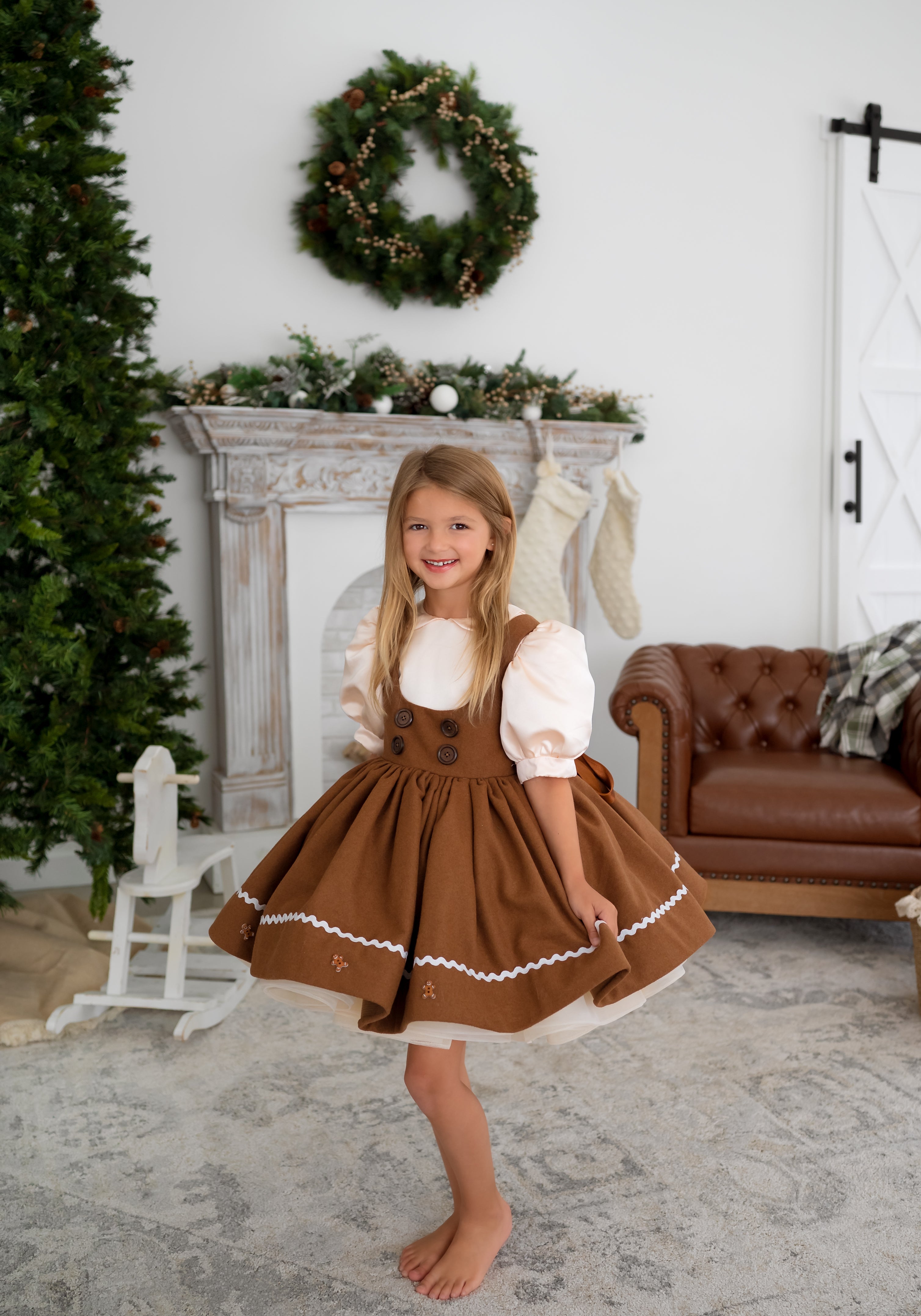 girl wearing a gingerbread apron dress