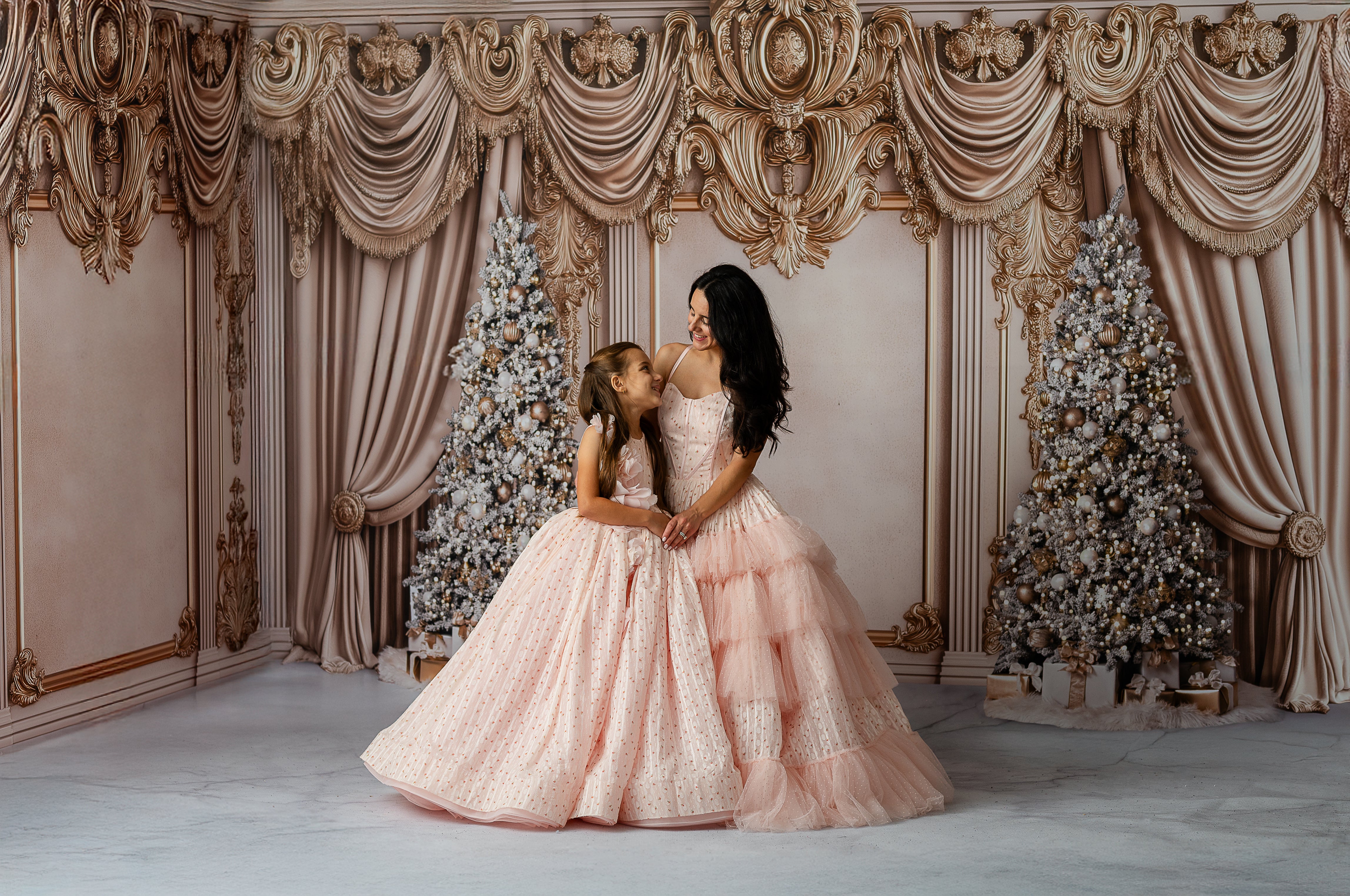 Blush pink girls couture gown with 3D floral appliqués and voluminous tulle skirt.
