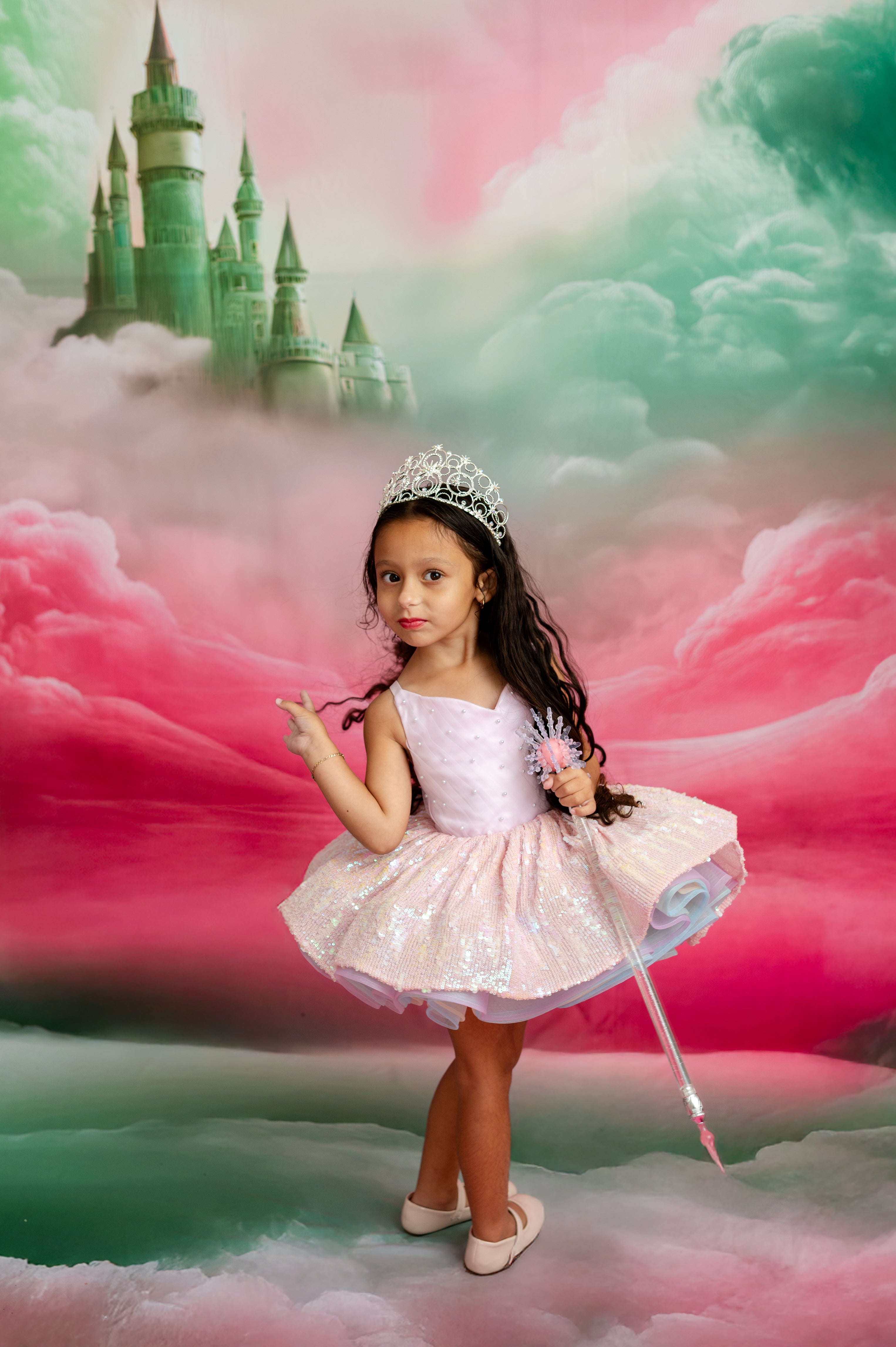 Young girl in a princess dress with a castle and clouds in the background