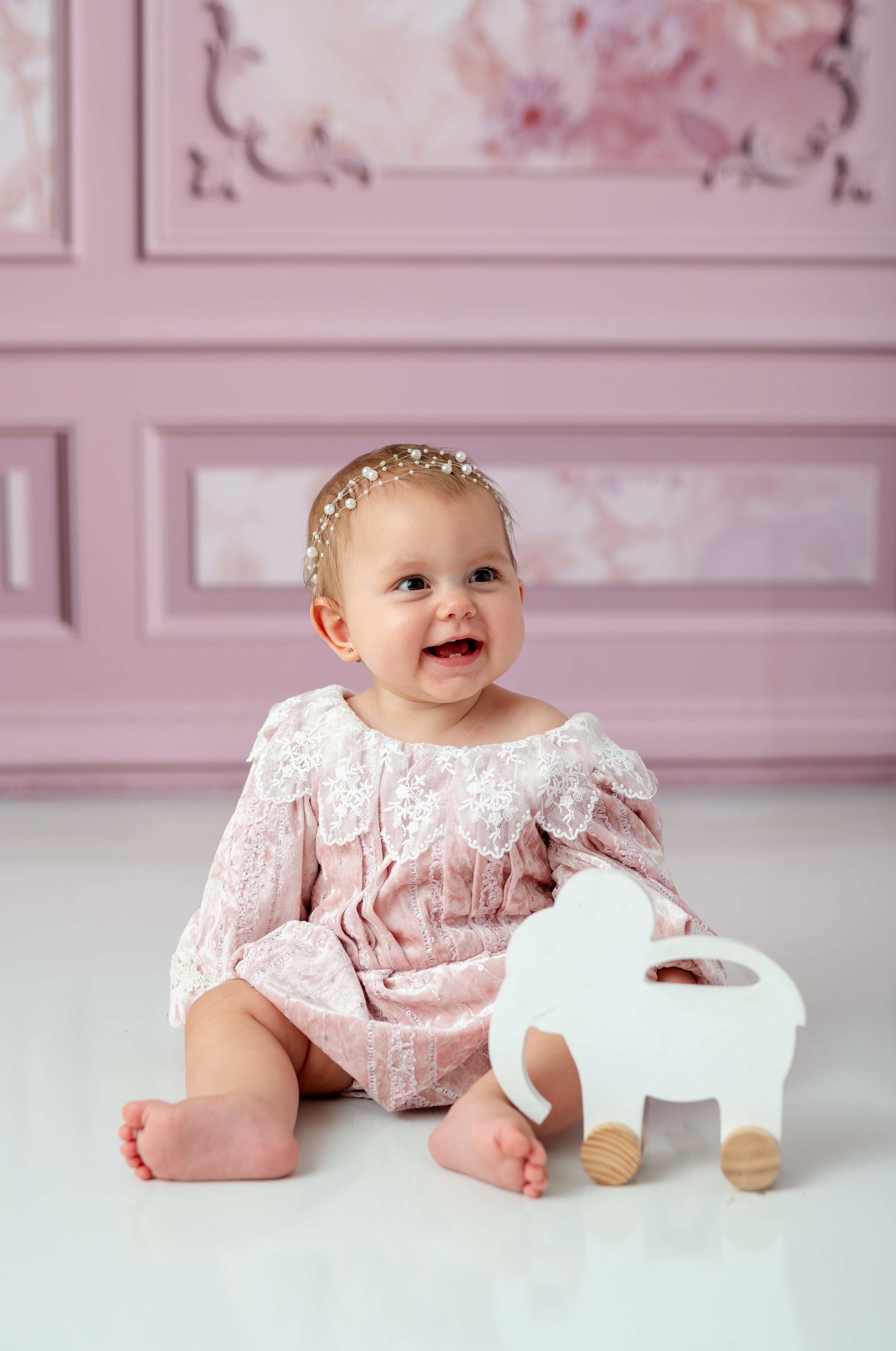 Baby in luxury lace romper during milestone photo shoot

