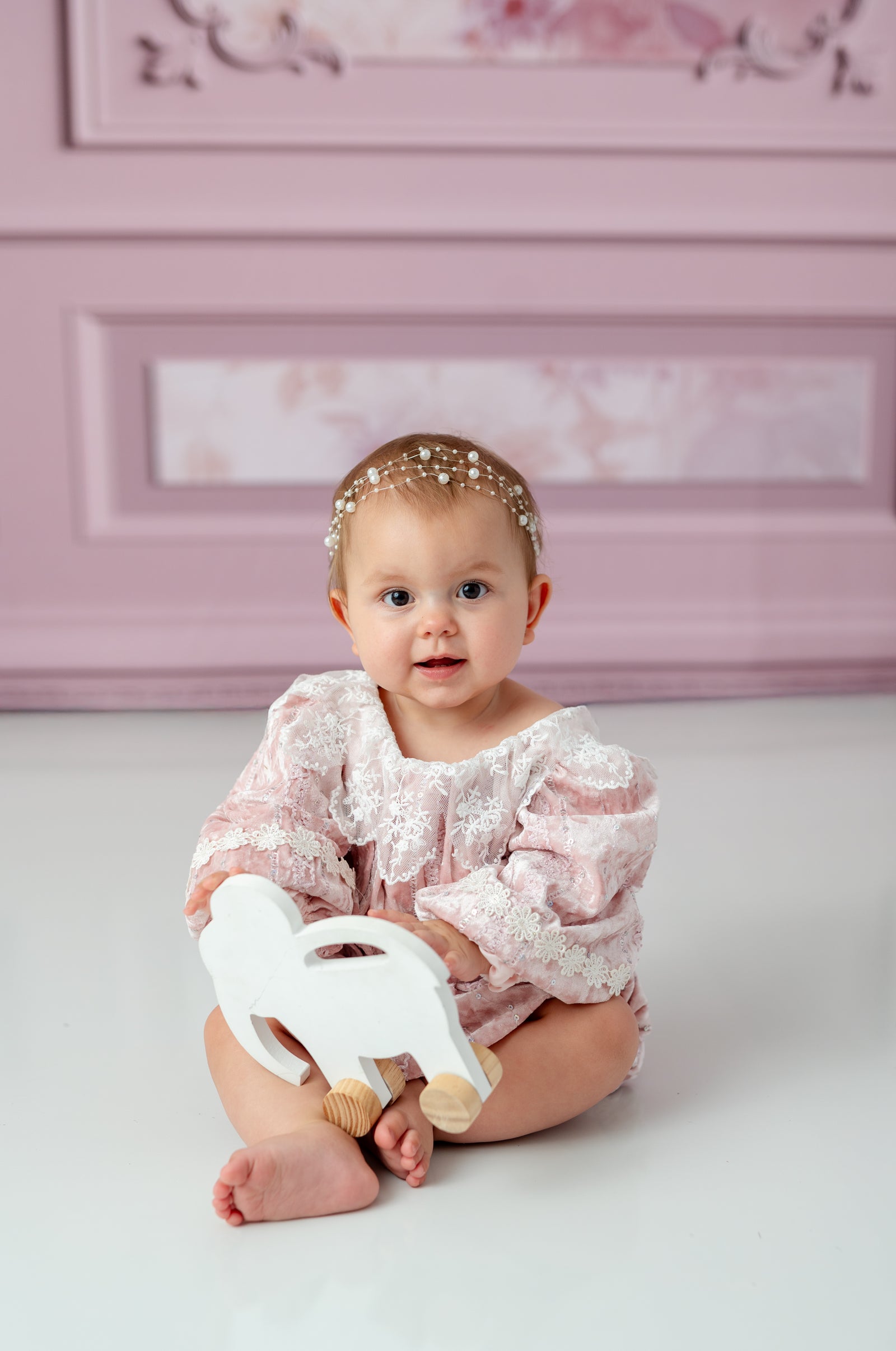 Side view of toddler in velvet and lace baby outfit

