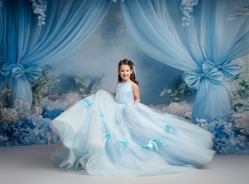 Elegant full-length tulle dress featuring a rounded neckline and adjustable ties.

