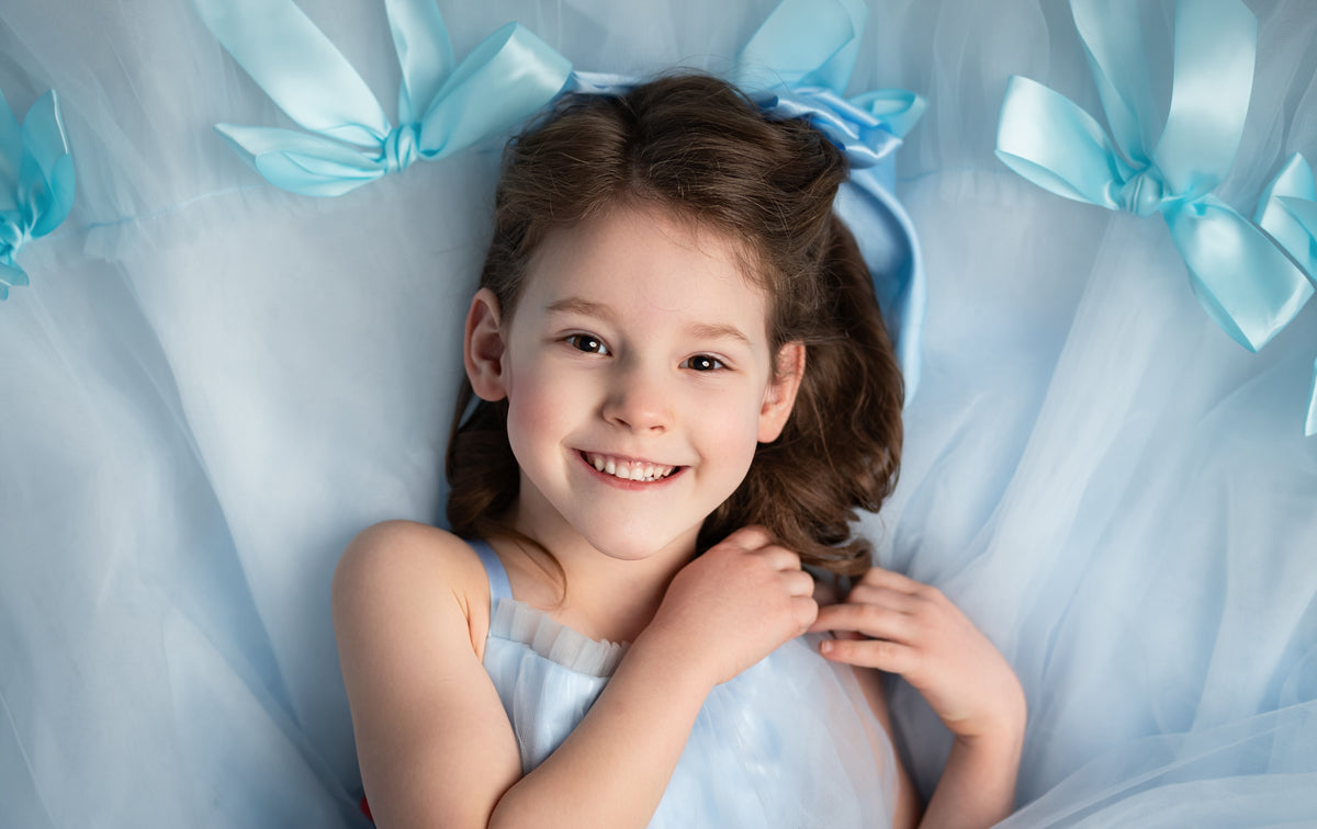 Graceful long gown adorned with handmade satin bows for a timeless look.

