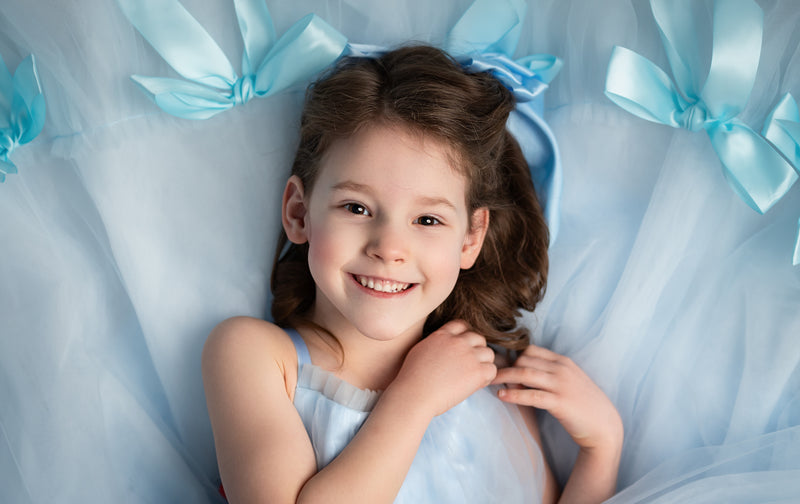 Graceful long gown adorned with handmade satin bows for a timeless look.

