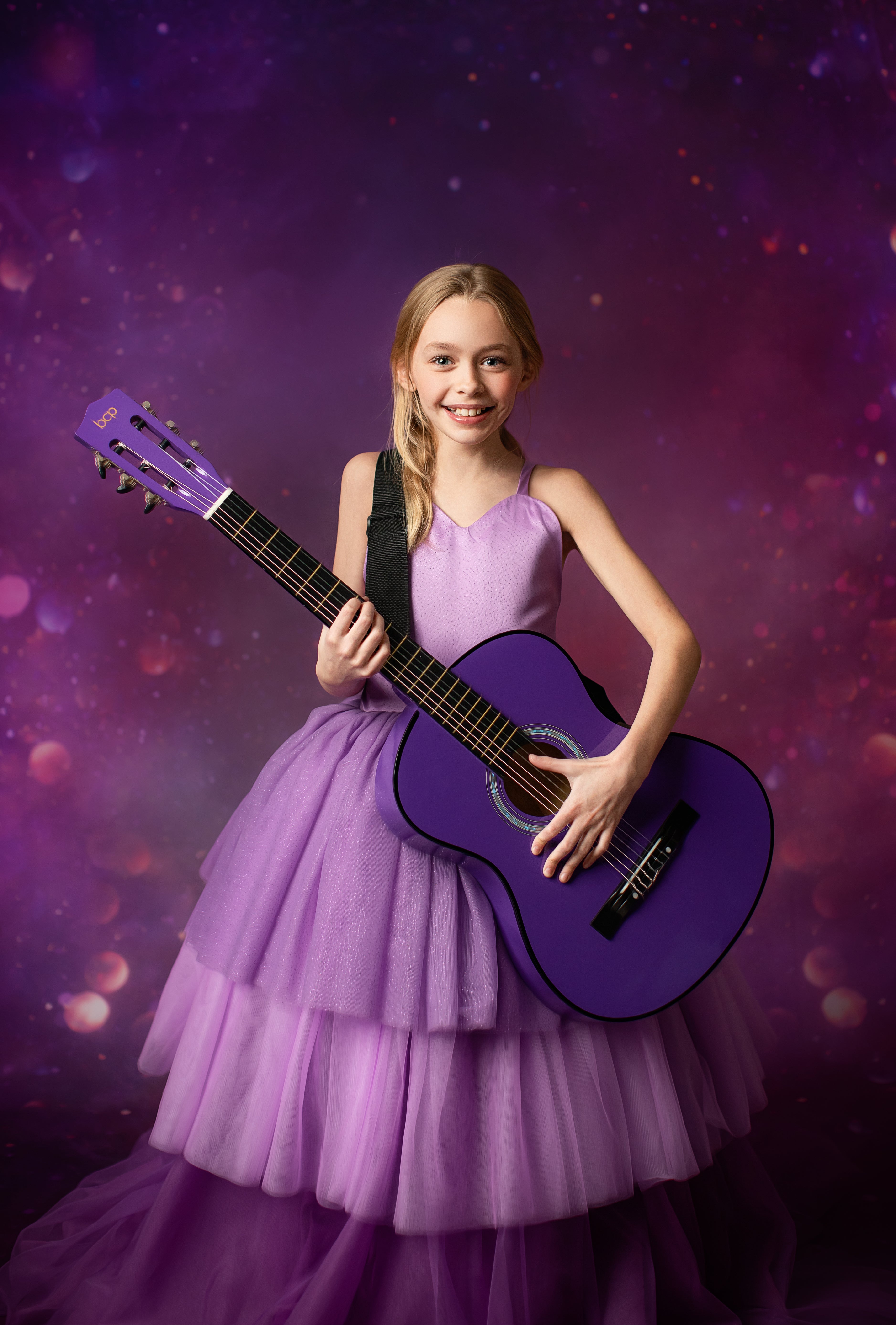 Young Swiftie in a lavender ball gown channels her inner Taylor Swift, singing passionately under a spotlight on a purple and blue stage.