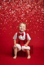 Child in a festive outfit with a red background
