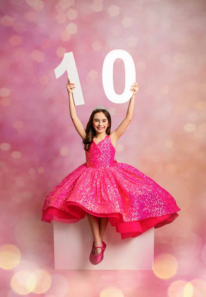 Girl wearing hot pink sequin birthday gown

