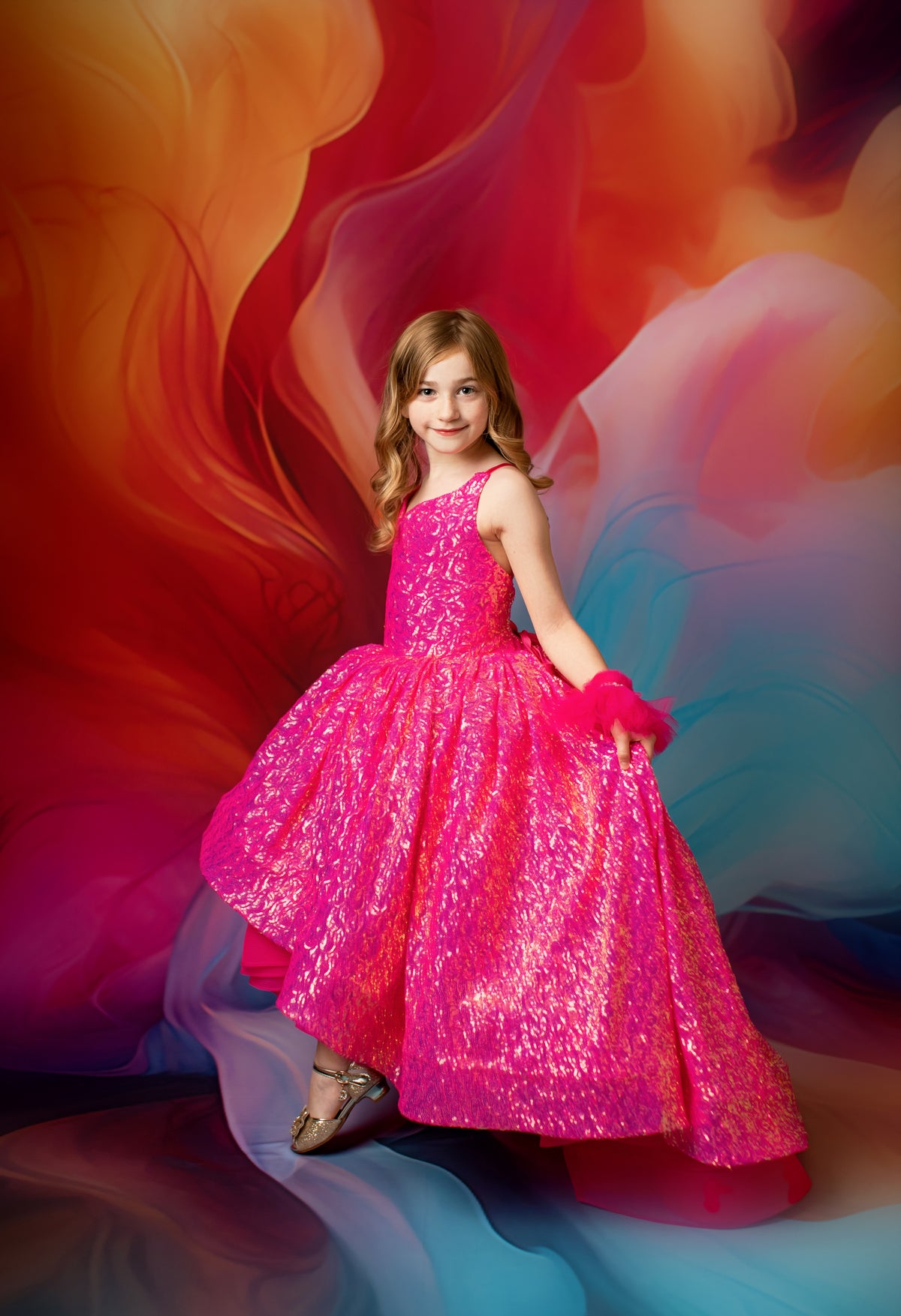 Girl in a vibrant pink sequin gown with adjustable shoulder ties.