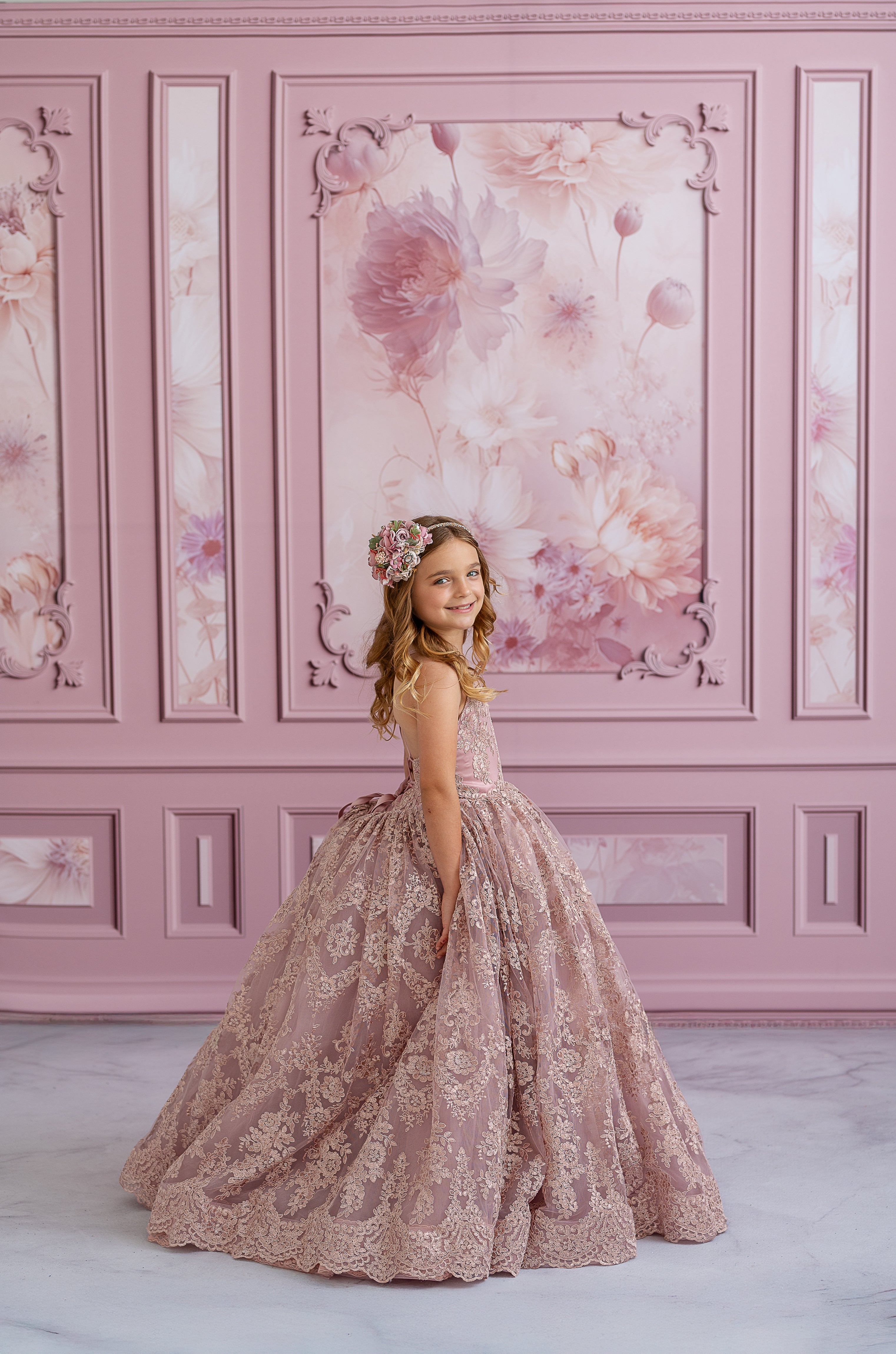 "Side profile of a floor-length couture gown showcasing delicate lace accents and classic design"

