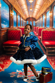 Young girl in a luxurious train car with red seats and gold accents.
