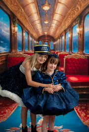 Two women in formal attire on a luxurious train car with red seats and ornate ceiling.