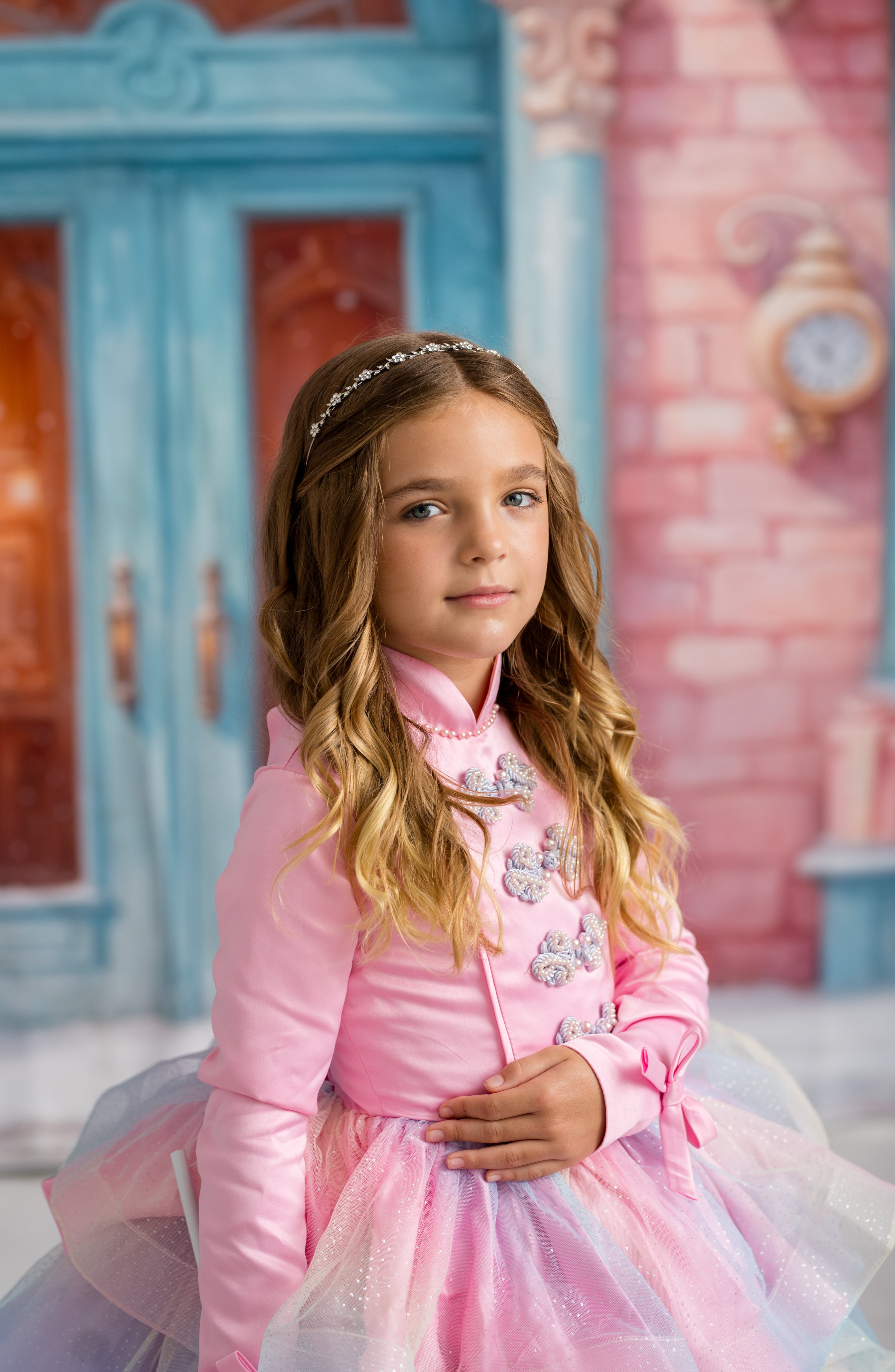Young girl in a pink dress with a castle background