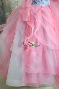 Enchanting pink princess gown with blue floral details and sheer puff sleeves.
