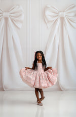 Close-up of Bentley + Lace dress showcasing plush velvet fabric and glossy satin accents.

