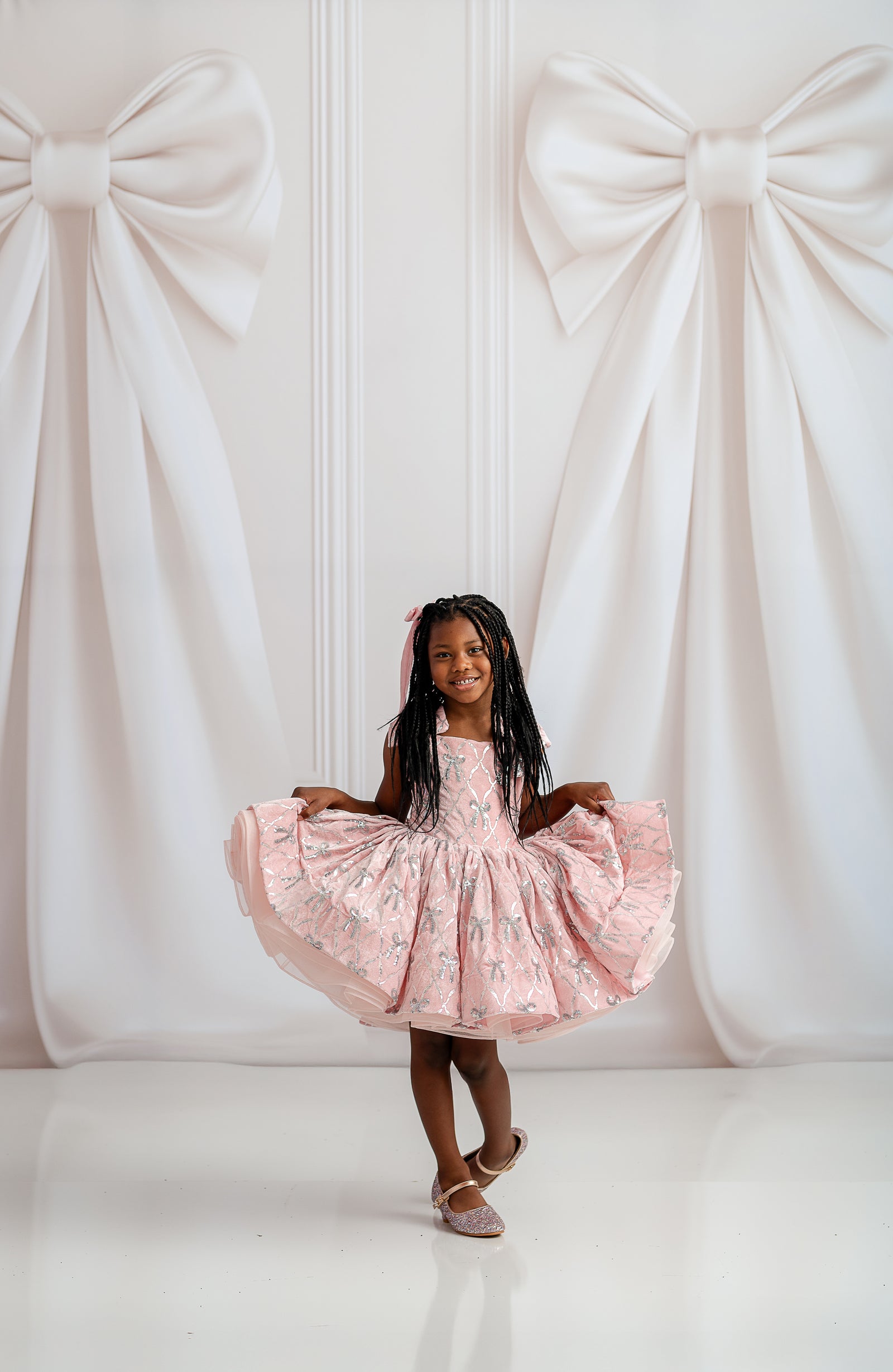 Close-up of Bentley + Lace dress showcasing plush velvet fabric and glossy satin accents.

