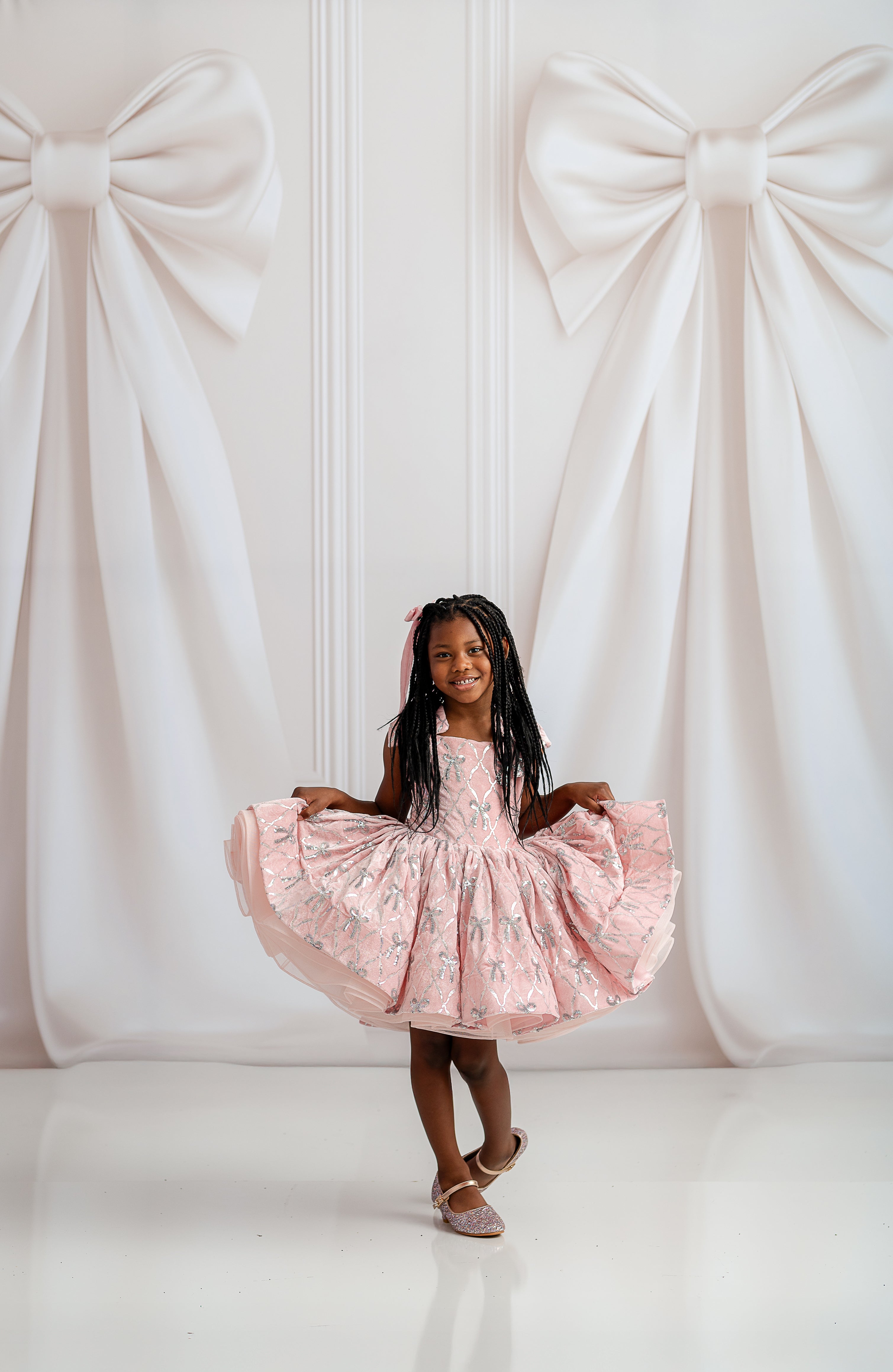 Close-up of Bentley + Lace dress showcasing plush velvet fabric and glossy satin accents.

