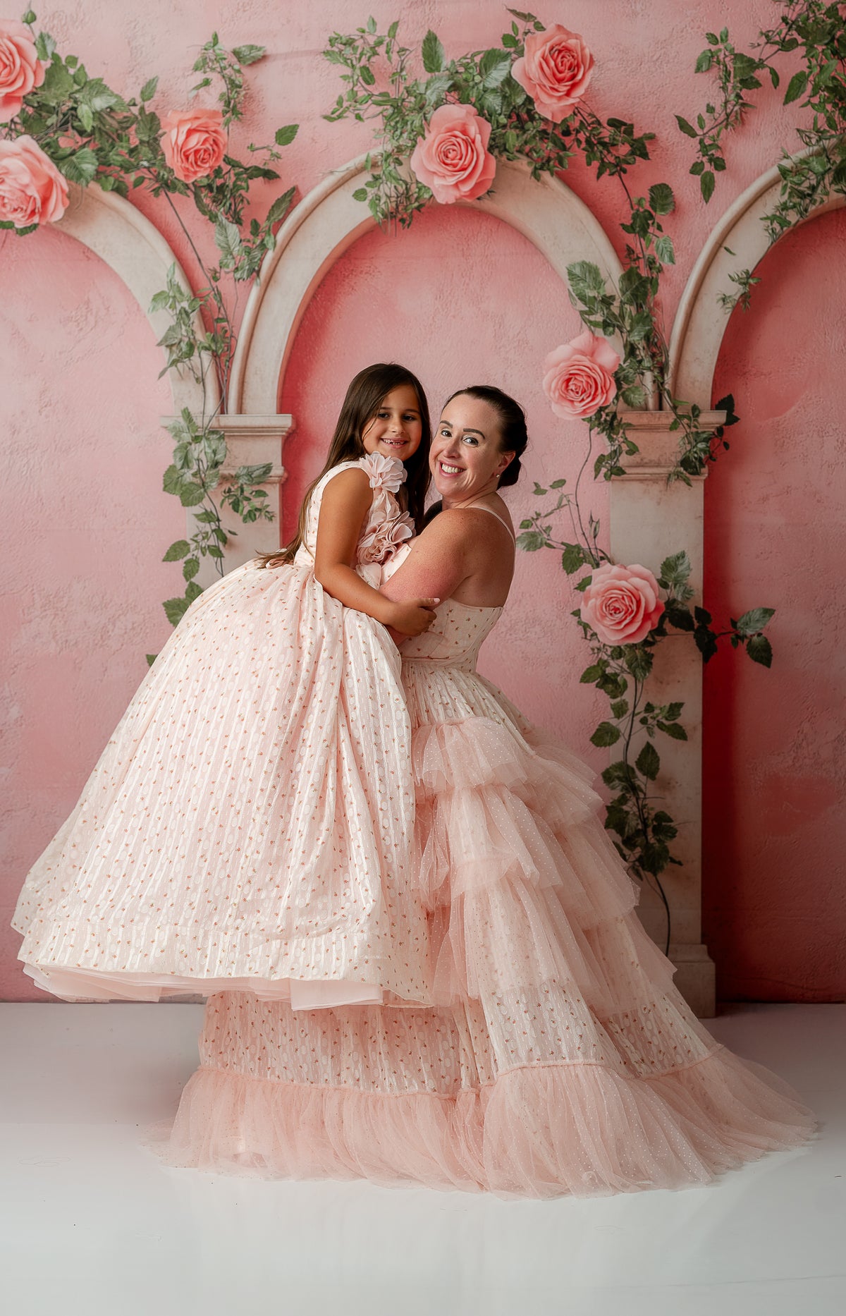 Mother and daughter wearing matching Sugar Rosette gowns in soft natural light