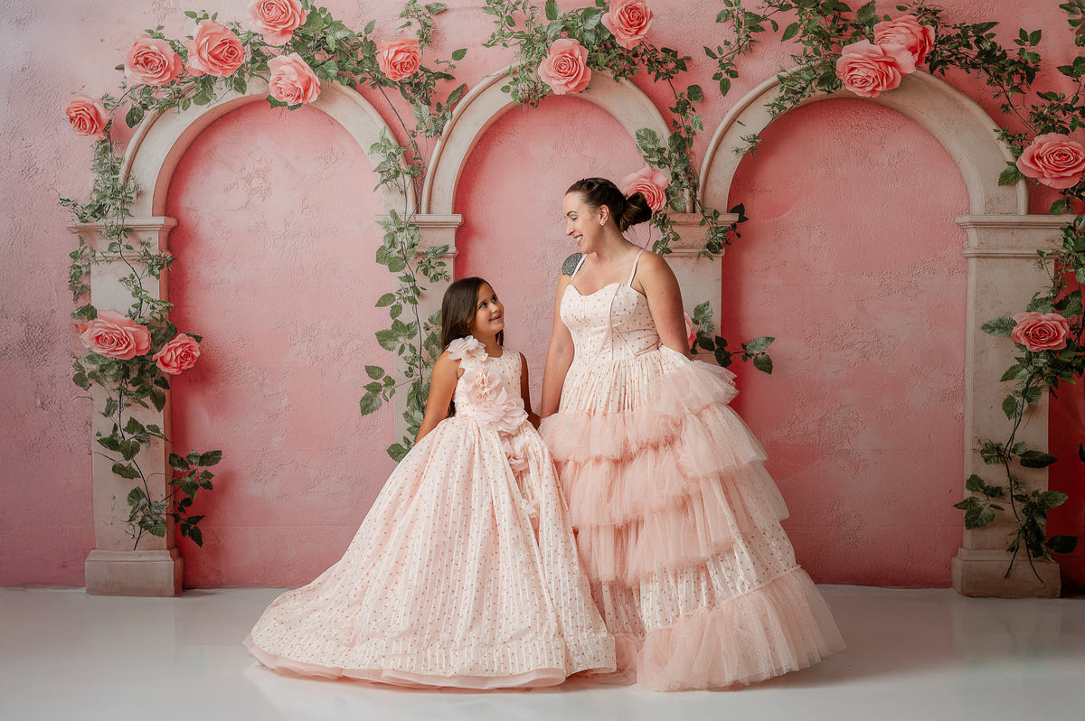 Coordinated mother-daughter twirl in romantic floor-length tulle gowns

