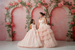 Coordinated mother-daughter twirl in romantic floor-length tulle gowns

