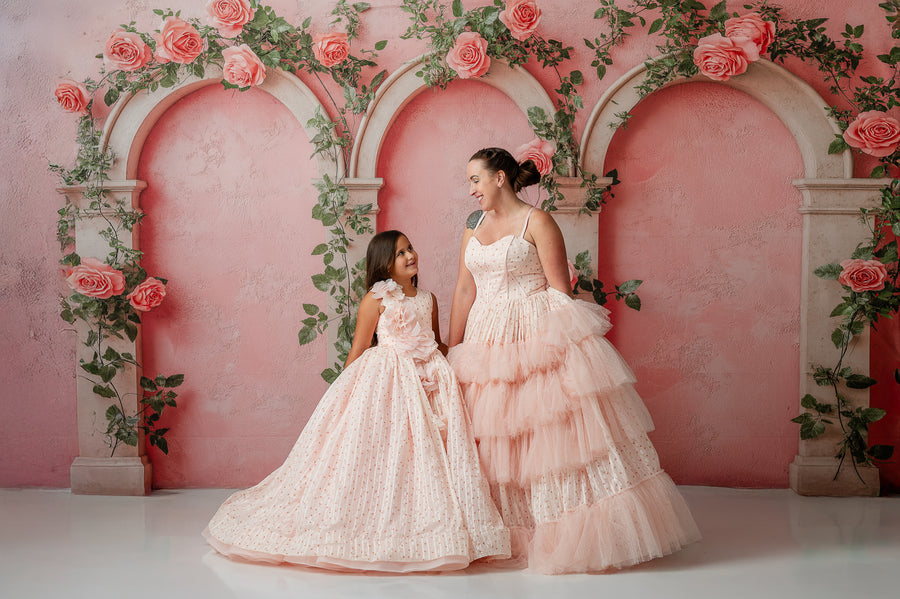 Coordinated mother-daughter twirl in romantic floor-length tulle gowns

