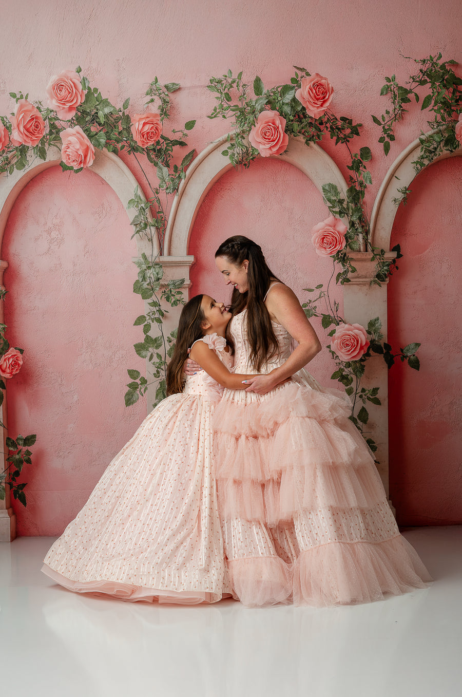 Mother and daughter embracing in Swiss dot tulle Sugar Rosette dresses

