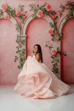 Little girl wearing Sugar Rosette gown in gentle blush with 3D floral appliqués

