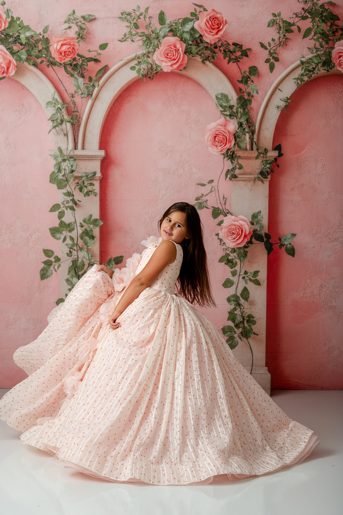 Side view of child in Sugar Rosette dress showing delicate dotted flower fabric

