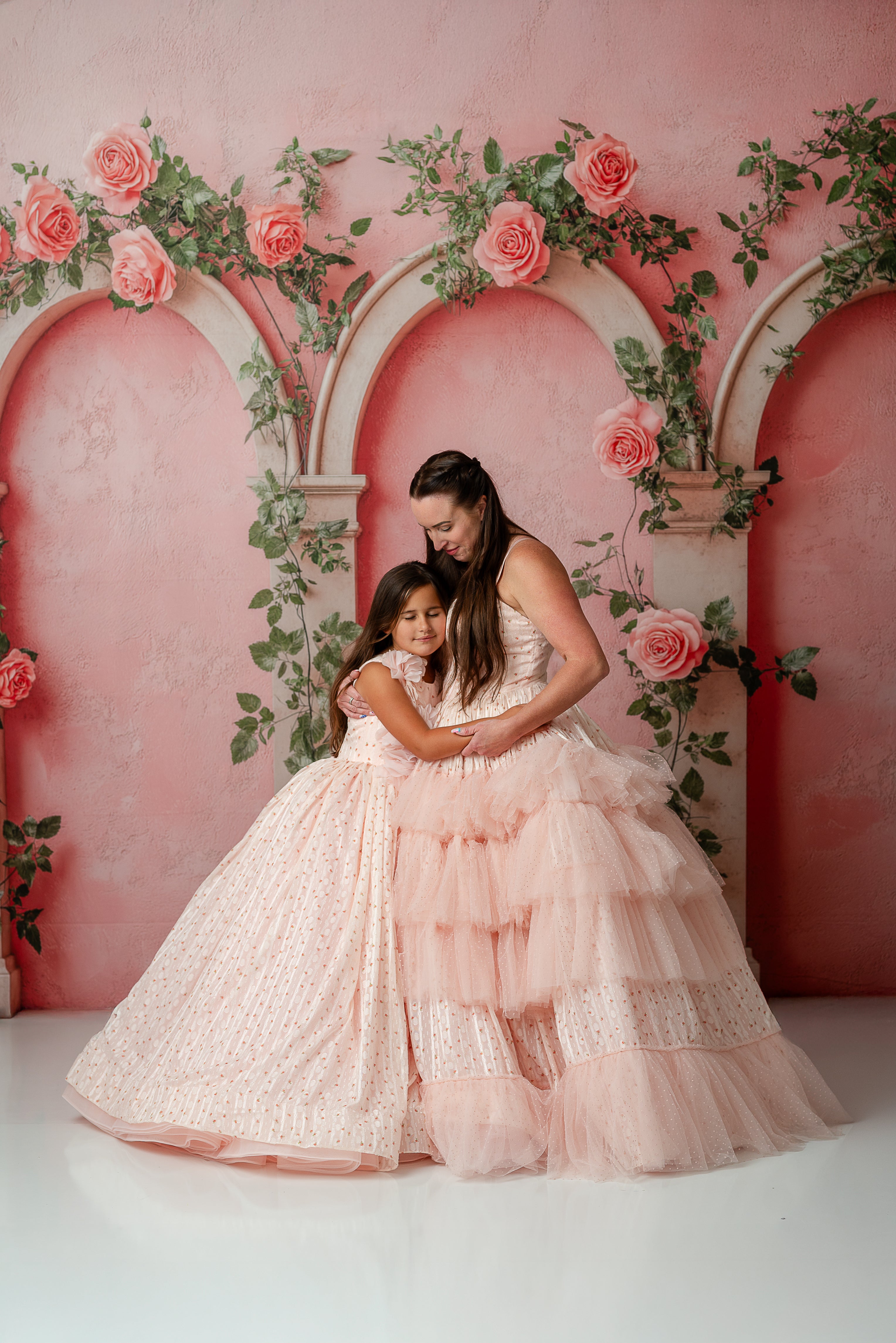 Blush pink girls couture gown with 3D floral appliqués and voluminous tulle skirt.

