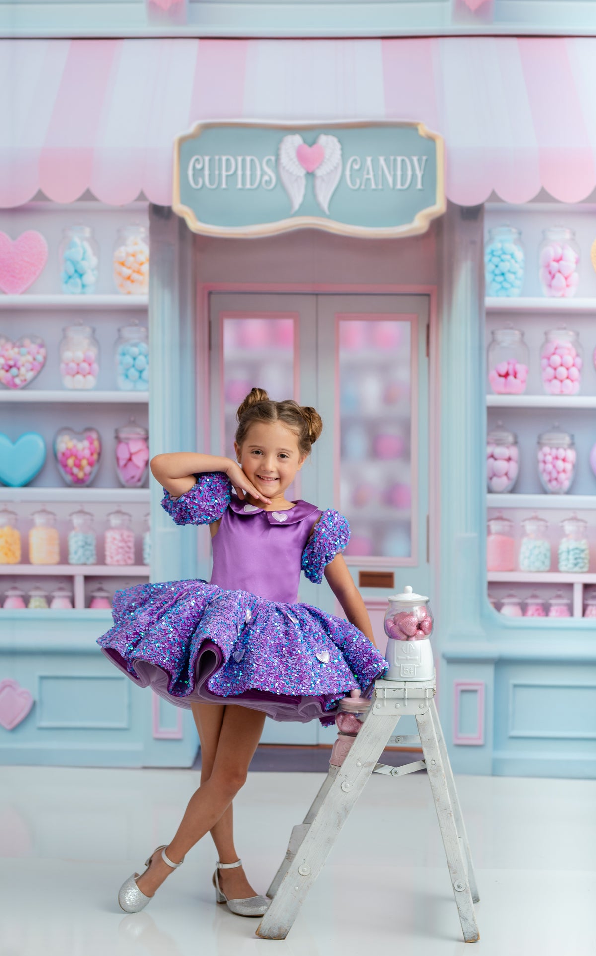 Couture lavender and sequin dress for girls with puff sleeves and full petal skirt, photographed in candy shop theme.