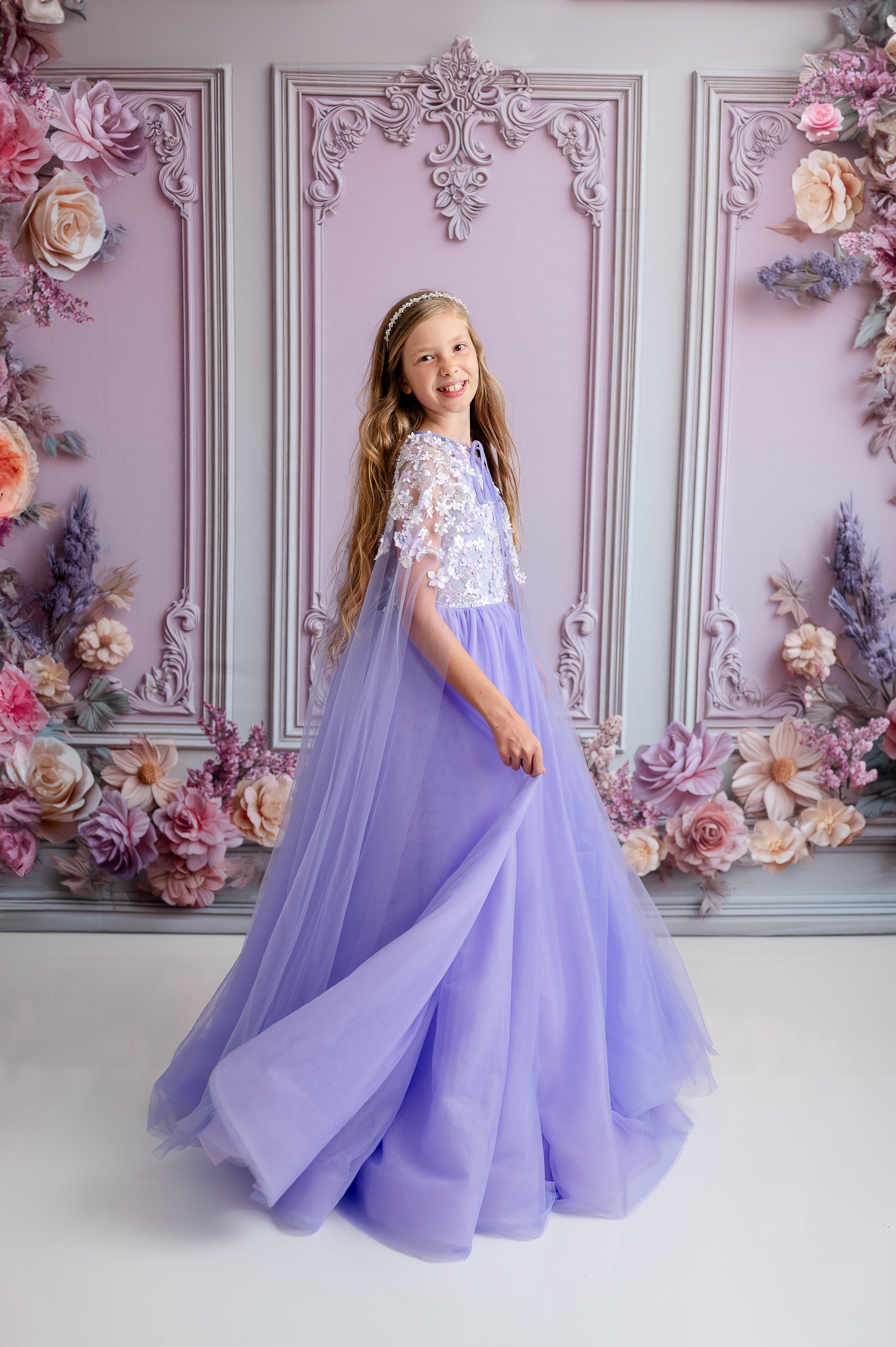 Girl wearing a lavender gown with matching cape