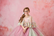 Graceful young girl wearing a stunning floral dress with delicate, detailed embroidery.

