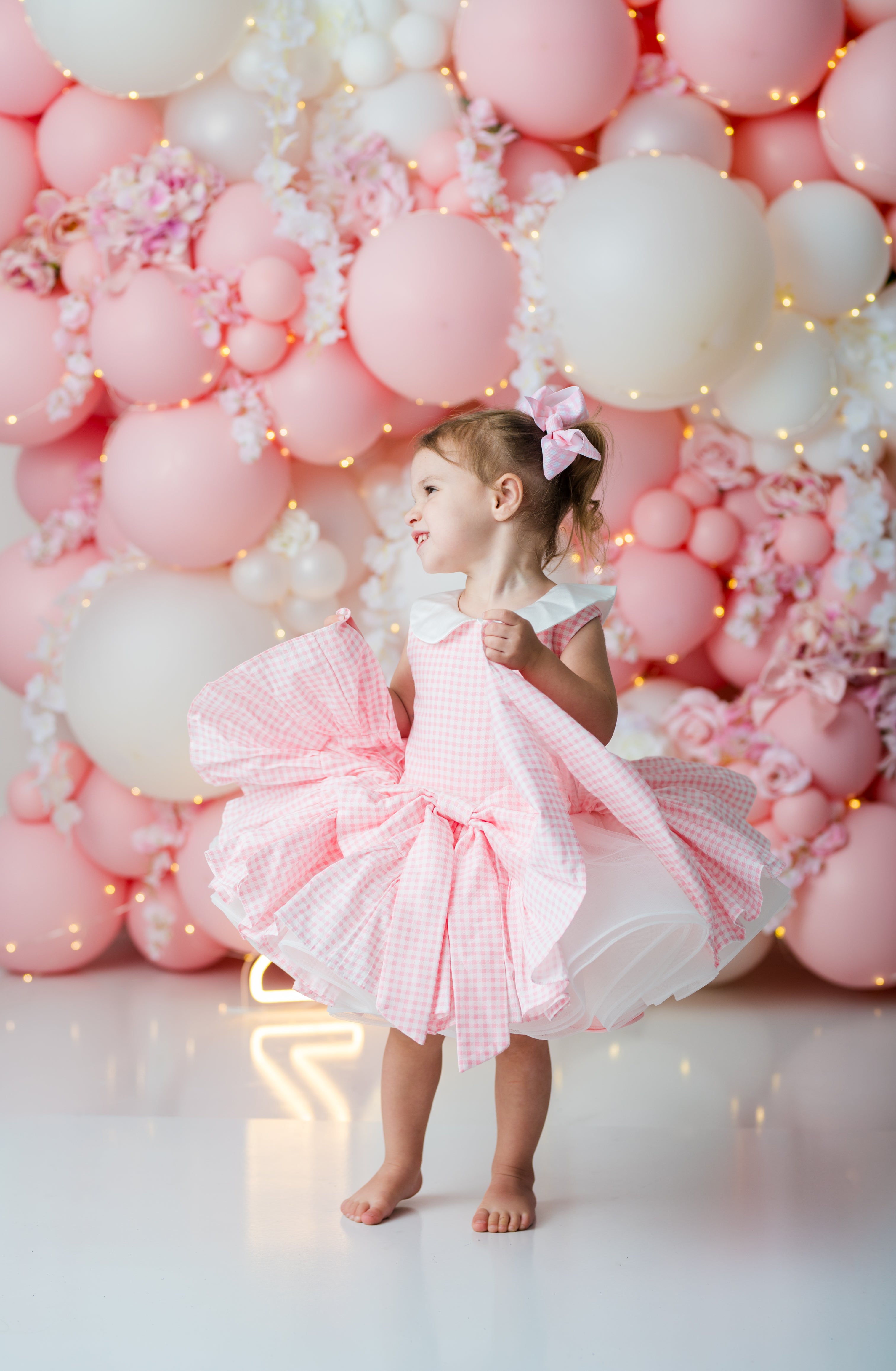 The Rosalie pink reversible dress with detachable gingham bow
