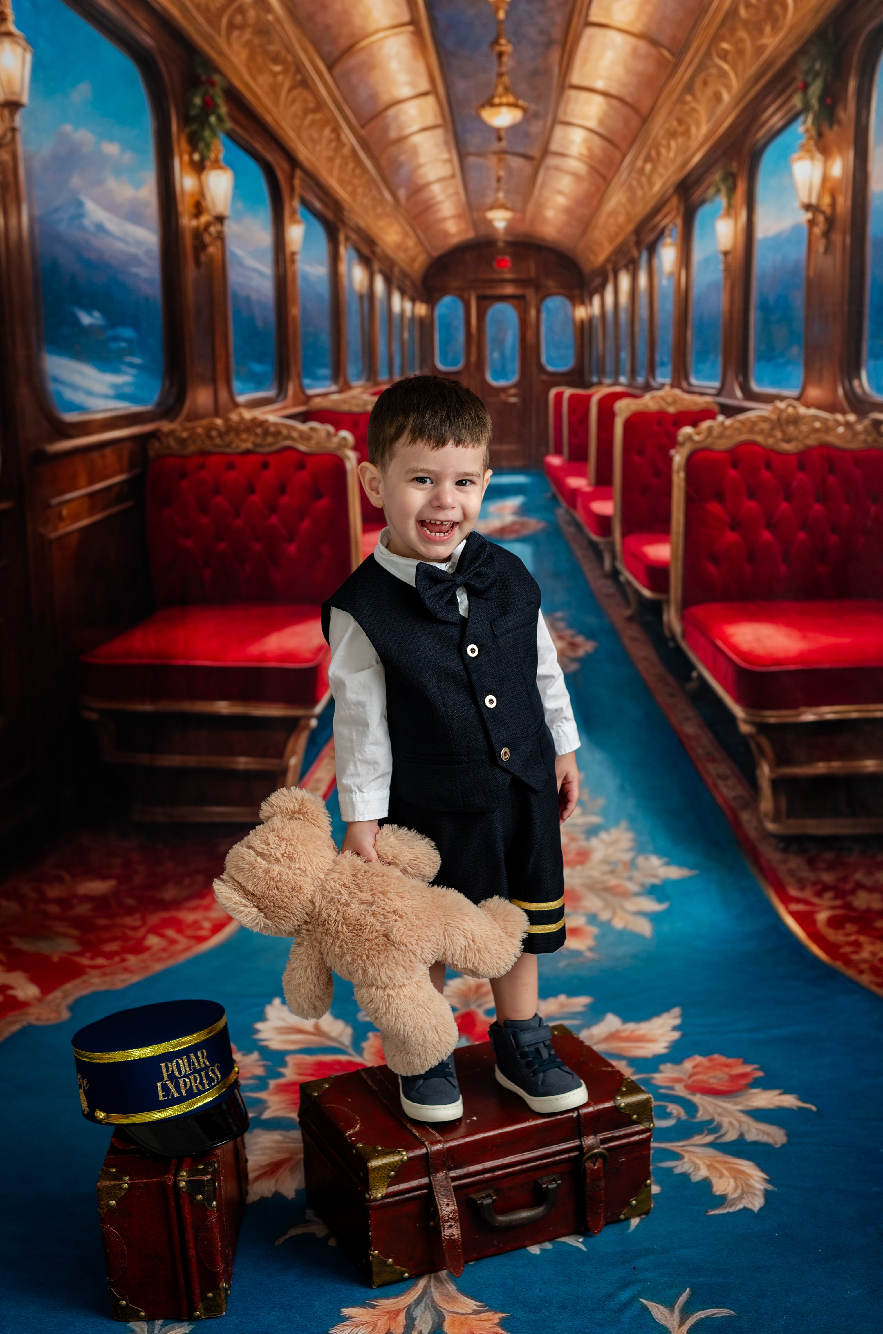 Child in formal attire with a teddy bear in a luxurious train car