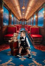 Child with a teddy bear in an opulent train carriage