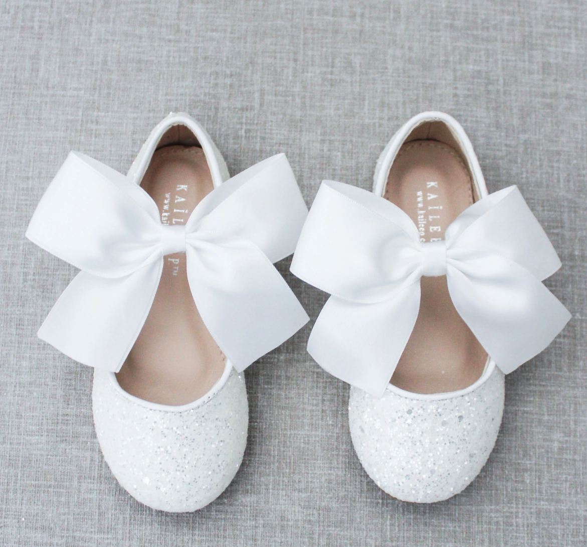 KAILEE P ballet flats featuring an allover rock glitter design with a matching satin bow, perfect for little girls' special occasions and photo sessions.