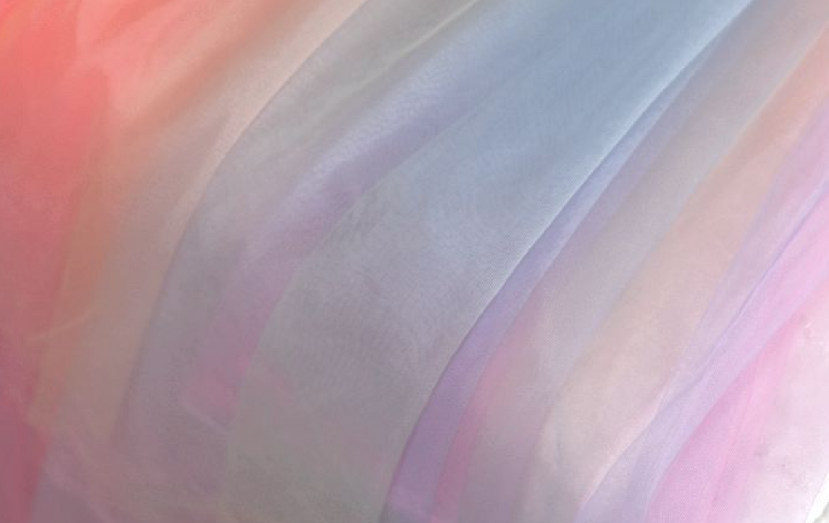Chasing Rainbows dress in soft pastel hues with detachable tulle sleeves, designed for elegance.
