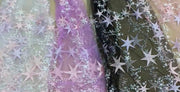 Sheets with star patterns in pastel colors on a textured background