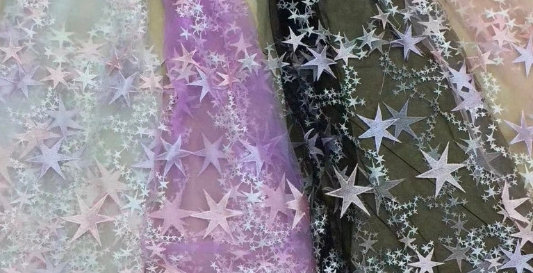 Sheets with star patterns in pastel colors on a textured background