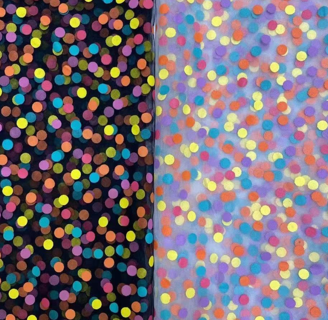 Two fabric swatches with colorful polka dot patterns on a dark and light purple background.