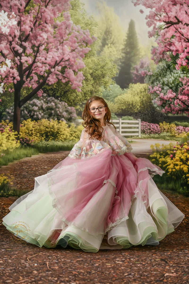 "Young girl in a stunning floral gown with vibrant, intricate patterns."
