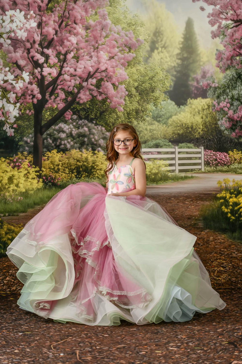 "Bright and cheerful floral gown on a young girl in a sunny outdoor scene."
