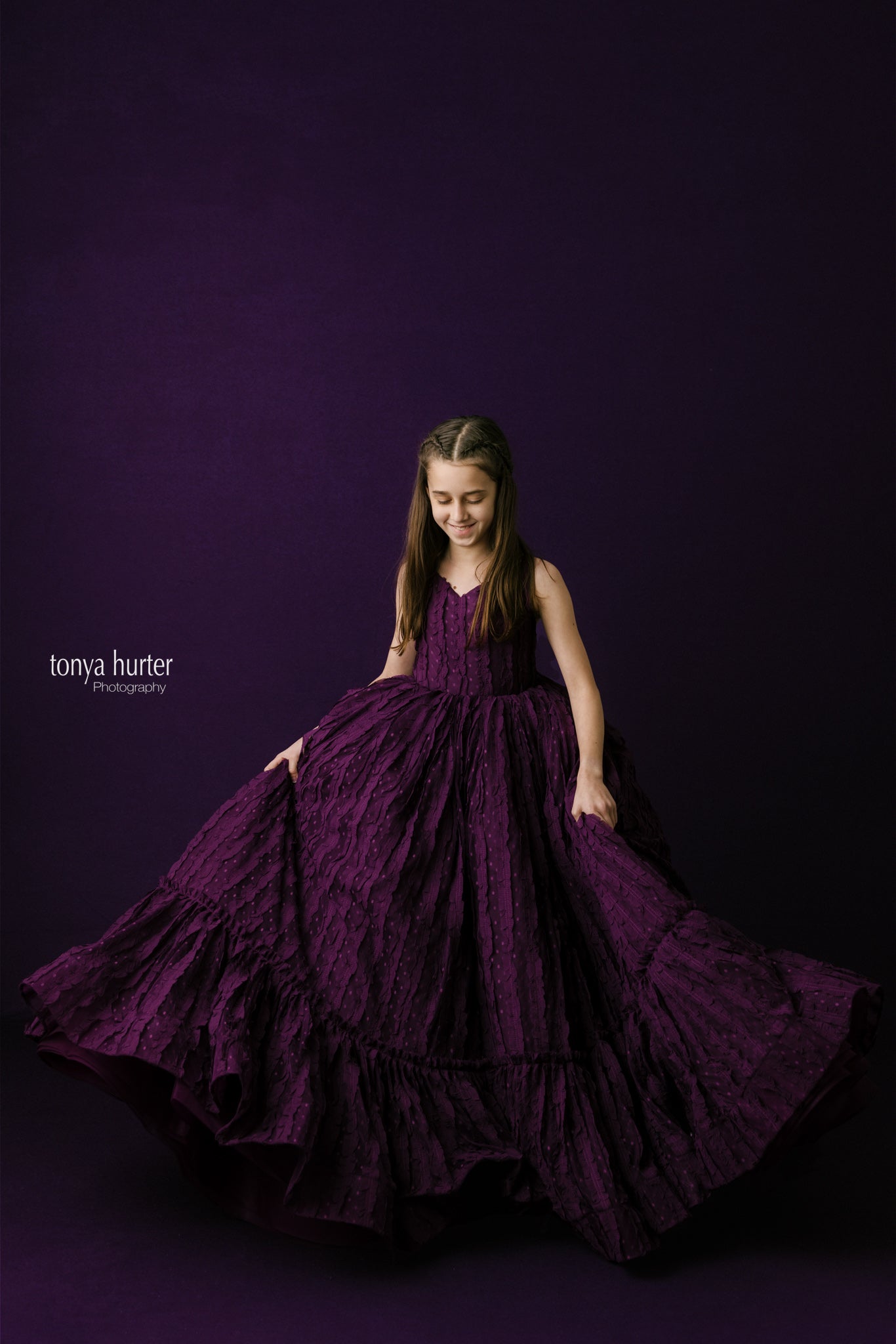 Deep purple couture gown with textured details and a dramatic flow, designed for stunning photography sessions.