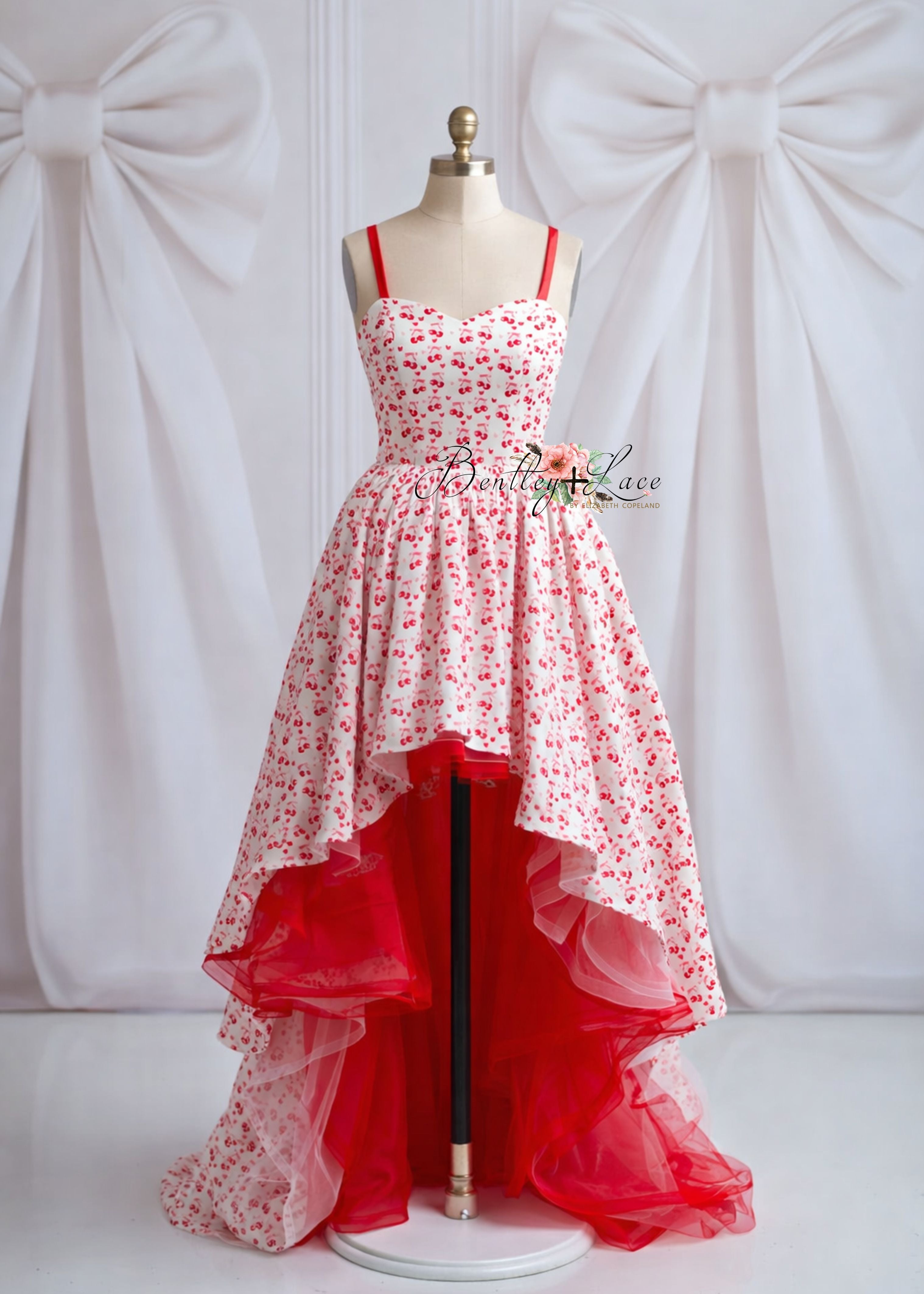 Red and white floral high-low dress on a mannequin against a white background