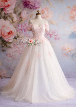 White wedding dress with floral details on a mannequin against a floral background