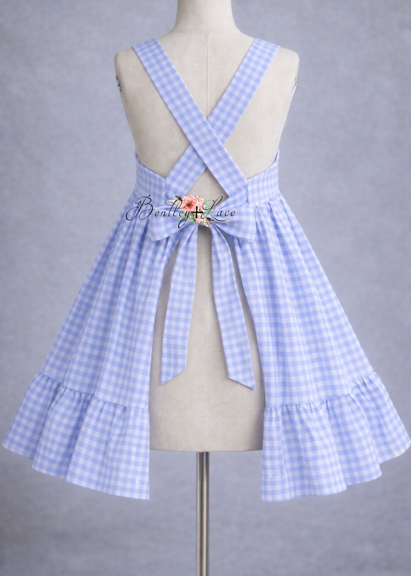 Blue and white checkered dress on a mannequin against a gray background