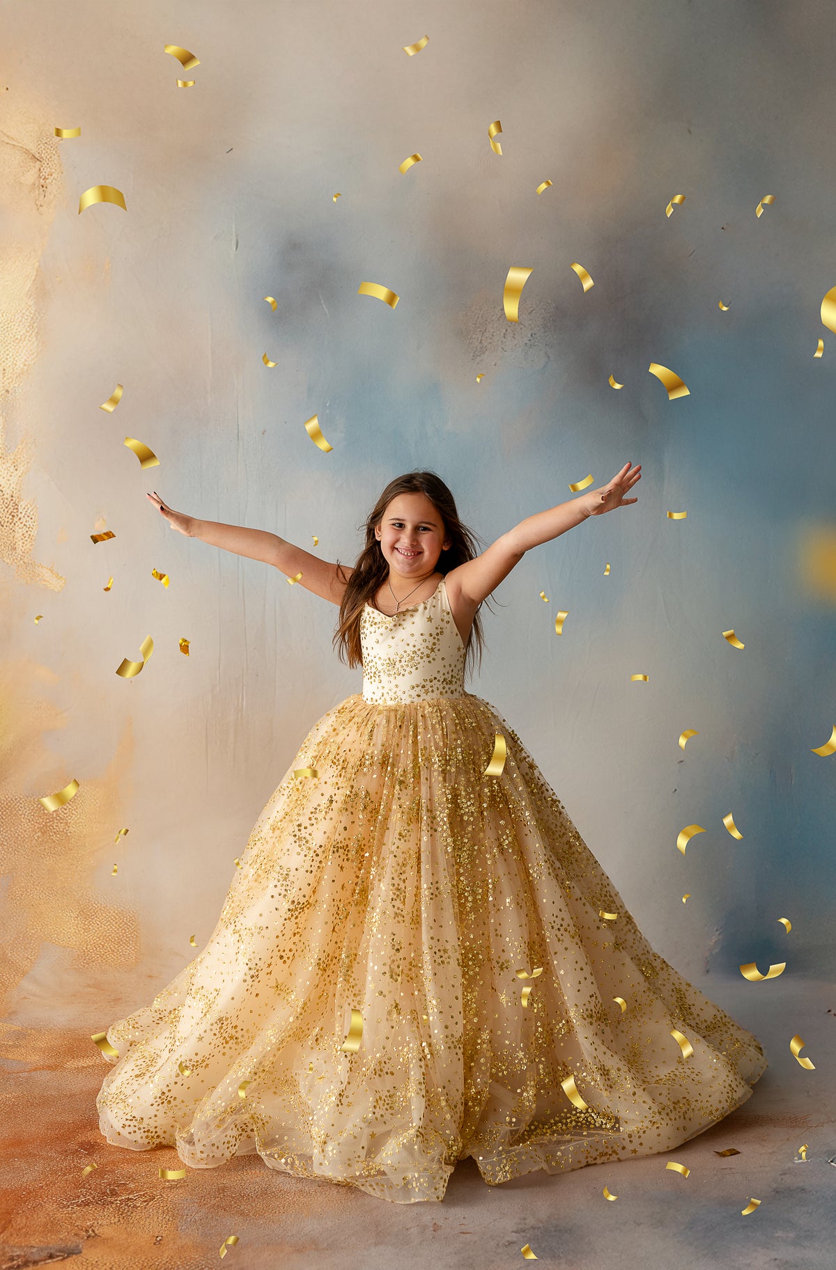 Girl twirling in gold star glitter gown with full tulle skirt


