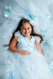 "Elegant couture gown with whimsical bow embellishments, styled for a dreamy photo shoot"

