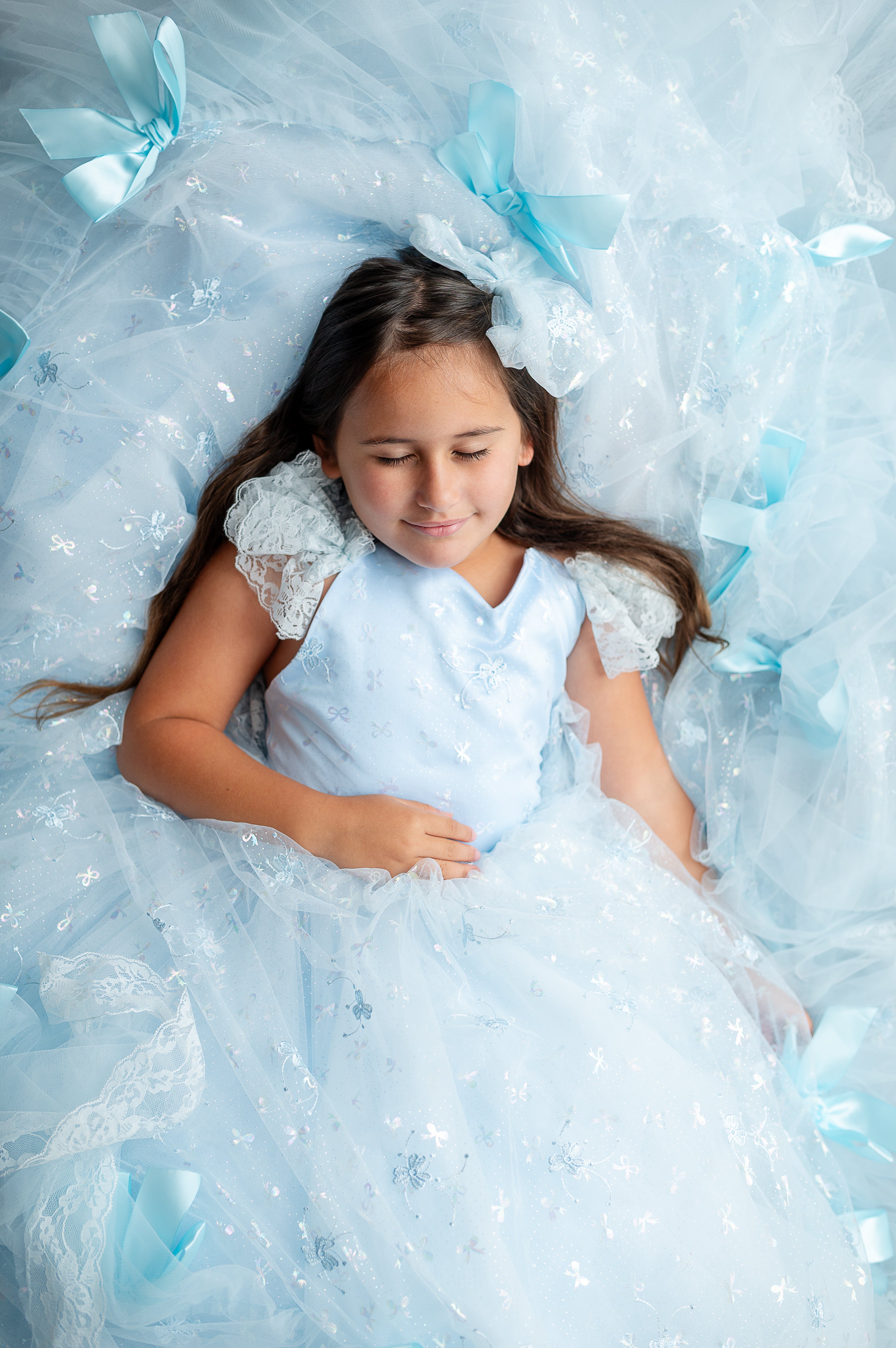 "Full-length special occasion gown in custom pastel shade with signature bow details"

