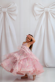 "Child wearing Pastel Clouds Dress, twirling in soft tulle layers under golden light"

