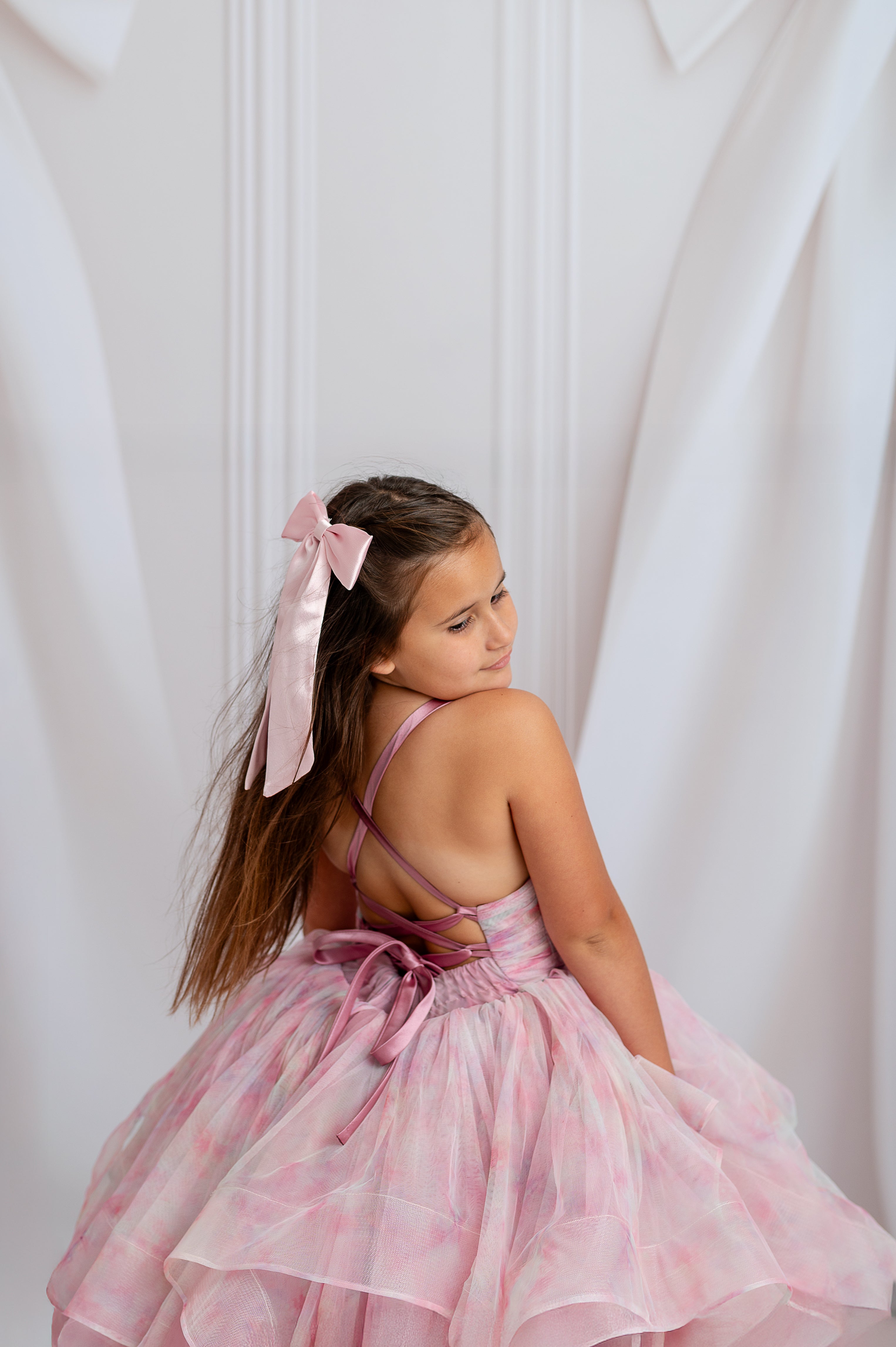 "Layered pastel tulle gown with optional sleeves for custom styling during special events"

